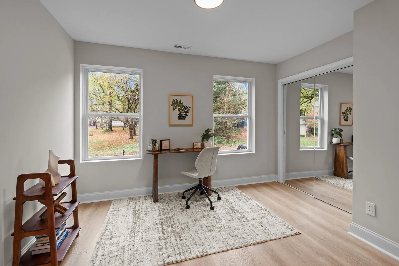 Staged kitchen with gray cabinetry, a wood island, and warm wood floors.